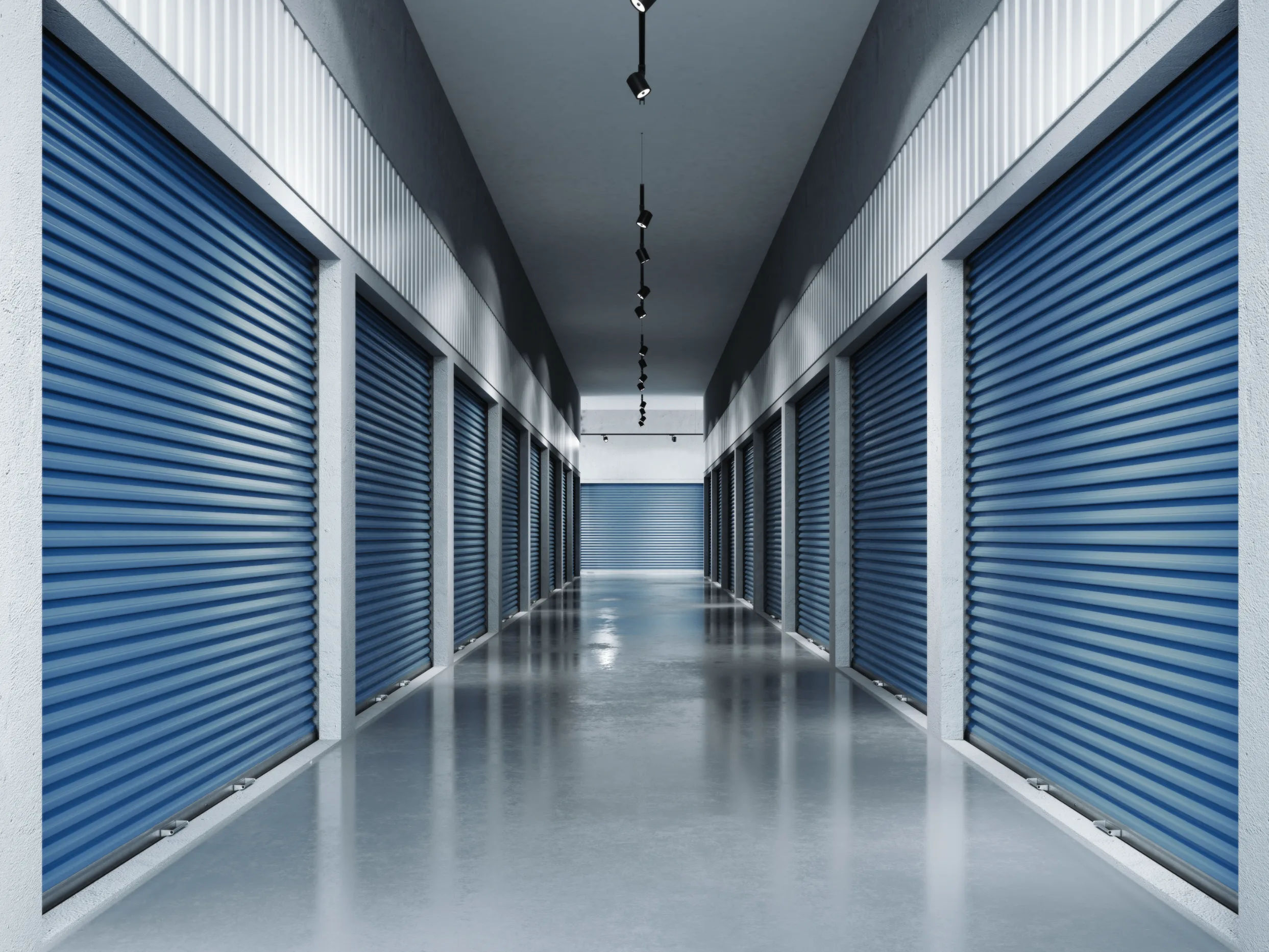 Indoor hallway lined with blue roll-up storage doors